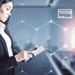DORA vs NIS 2: professional with a tablet and cyber security graphics